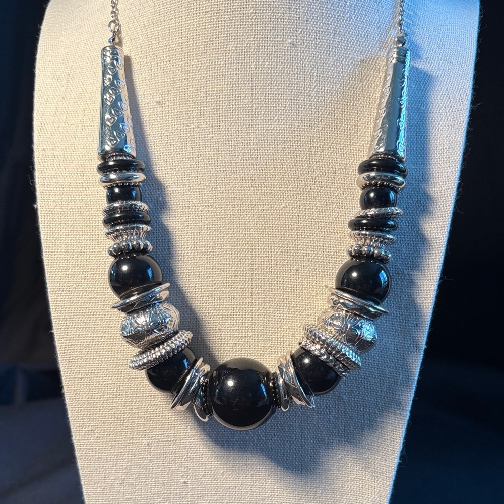 Woman’s  statement necklace with black acrylic beads and silver-tone spacers.
